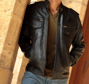 Man wearing a black leather motorcycle jacket, built for protection and style on the road.