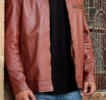 Man wearing a stylish genuine sheepskin jacket, perfect for winter warmth and rugged fashion.