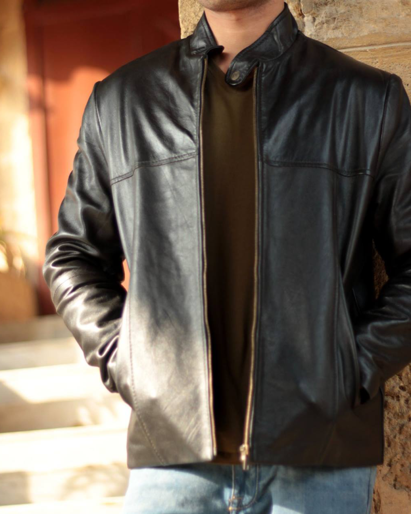 Man wearing a stylish genuine sheepskin jacket, perfect for winter warmth and rugged fashion.