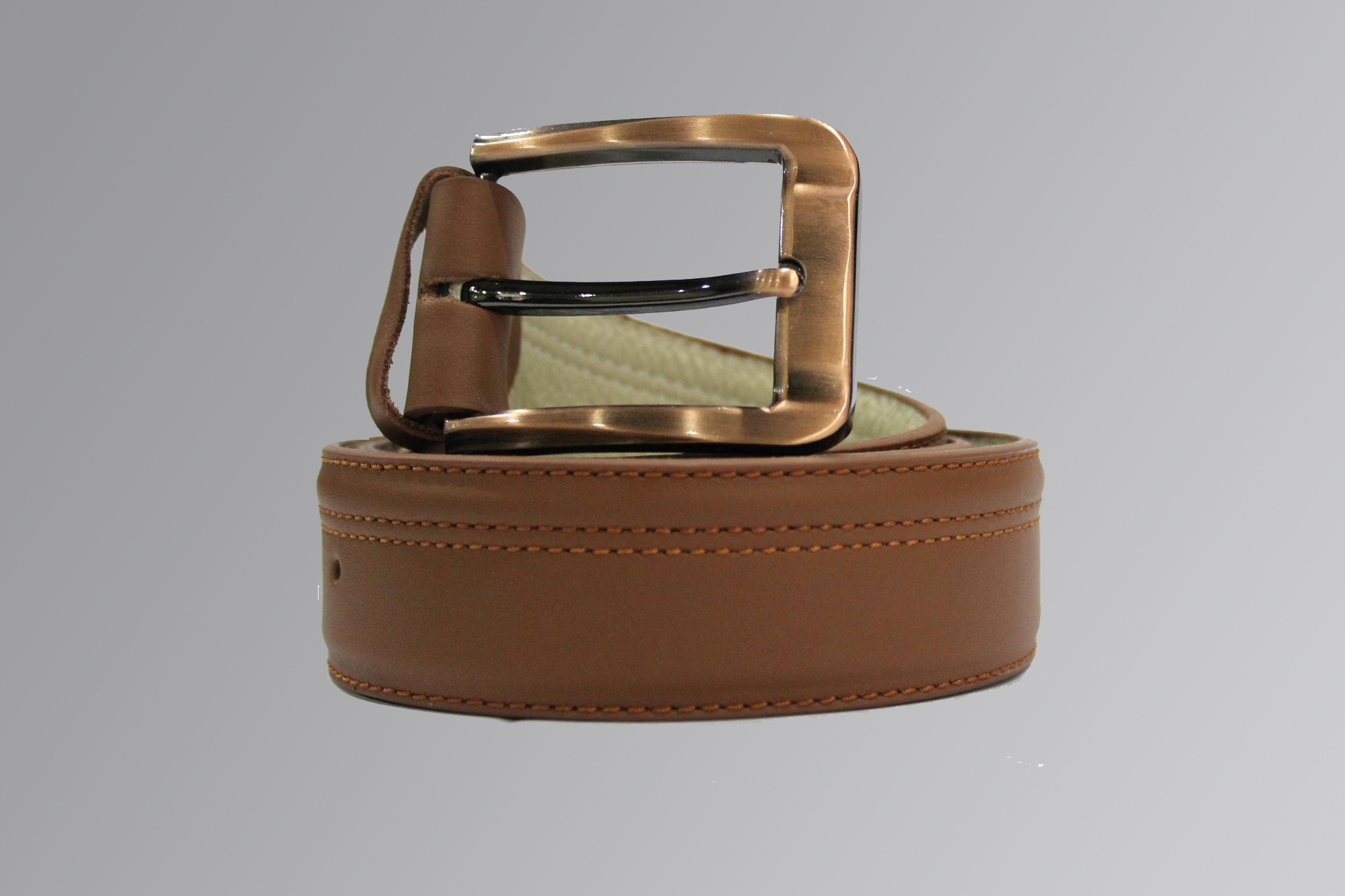 Leather belt with center stitching and metal buckle on light background