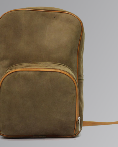 Brown leather backpack with front pockets and adjustable straps on neutral background