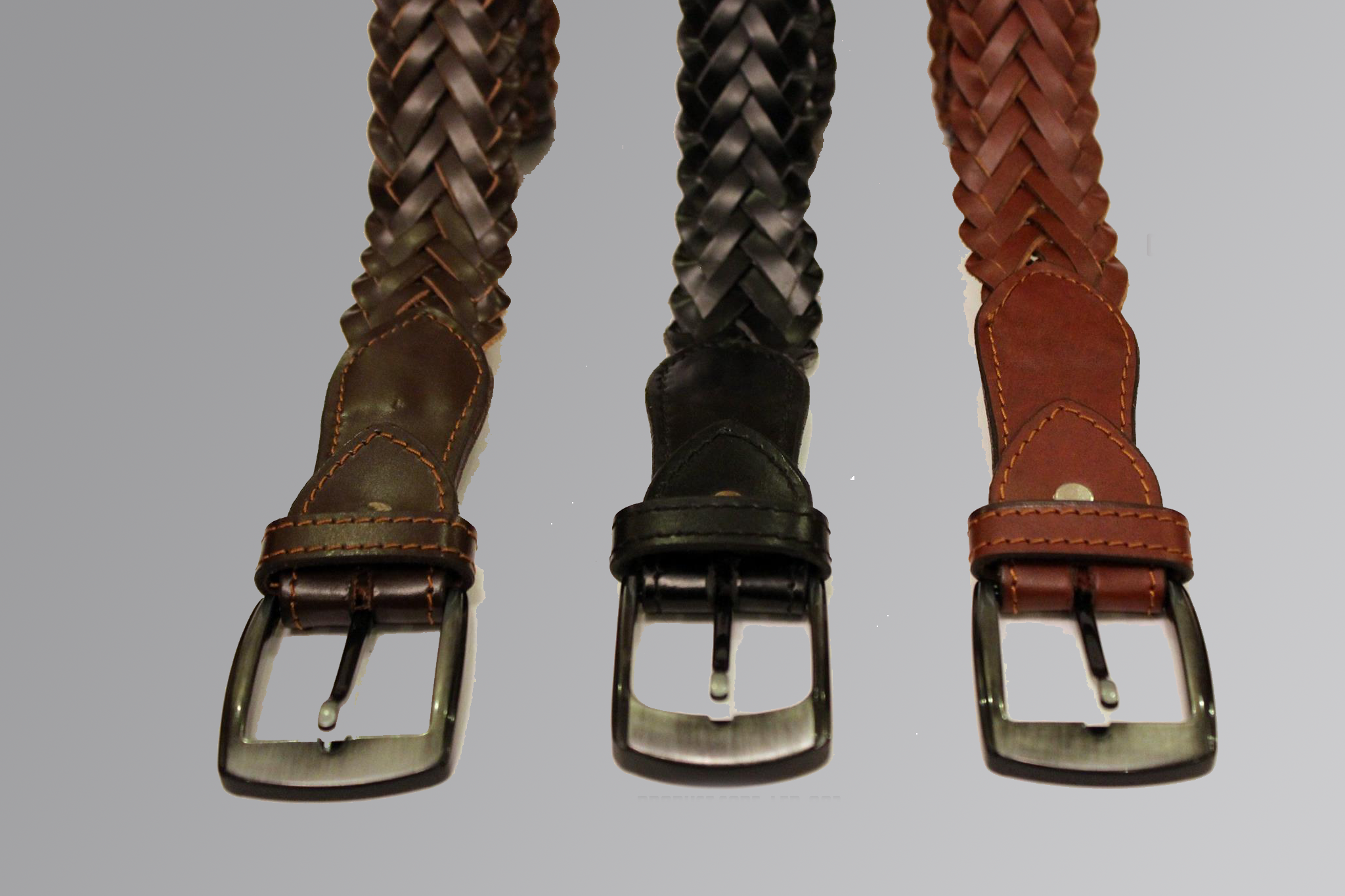 Leather belt with embossed cross design and metal buckle on plain background