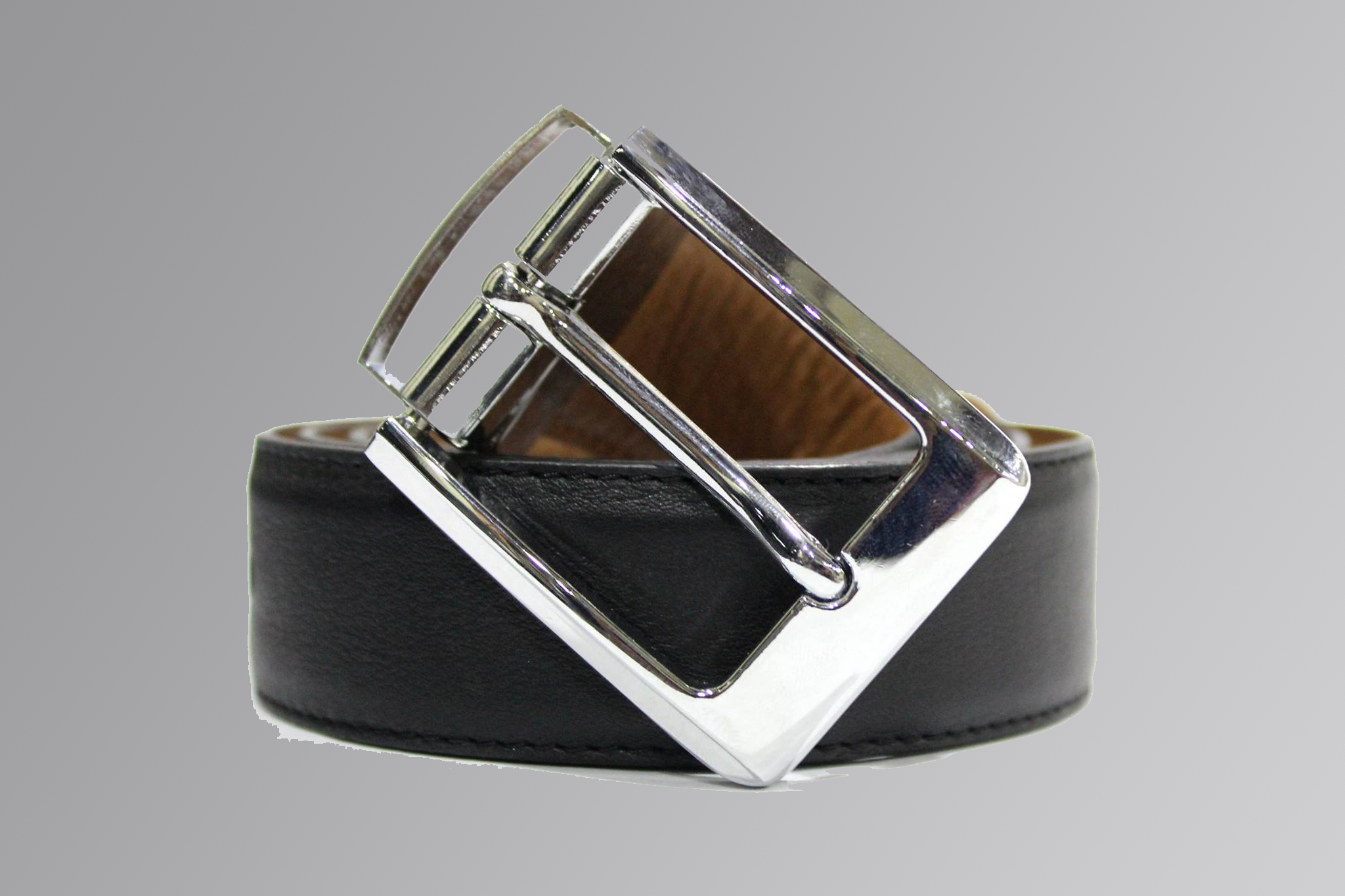 Double-sided reversible leather belt with rotating buckle on white background