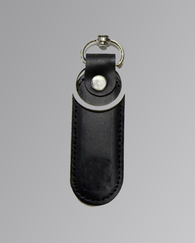 Handmade brown leather keychain with metal ring on white background