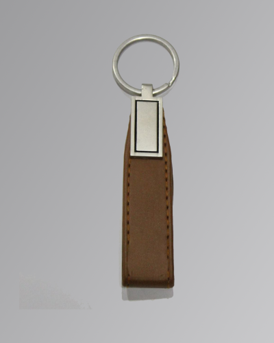 Handmade brown leather keychain with metal ring on white background