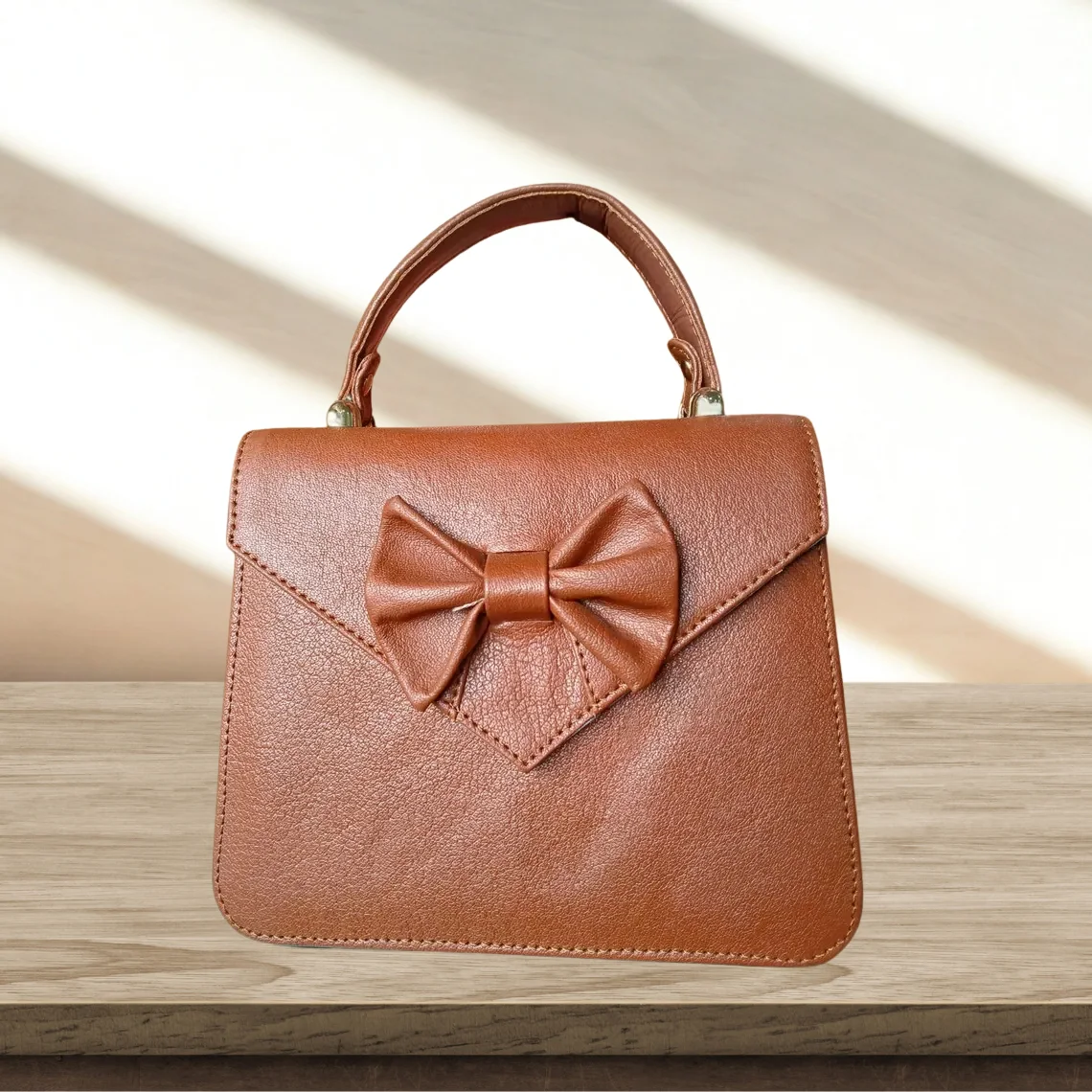 Leather Hill Bow Satchel in camel brown