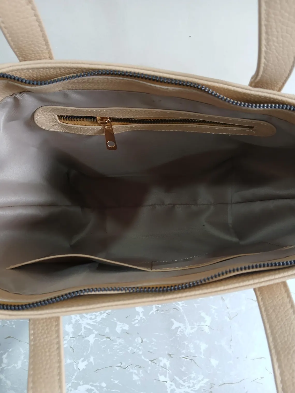 Leather Hill beige tote bag interior with zippered pocket